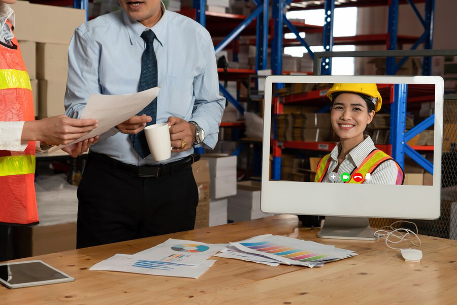 warehouse staff talking video call computer screen storage warehouse 31965 21140